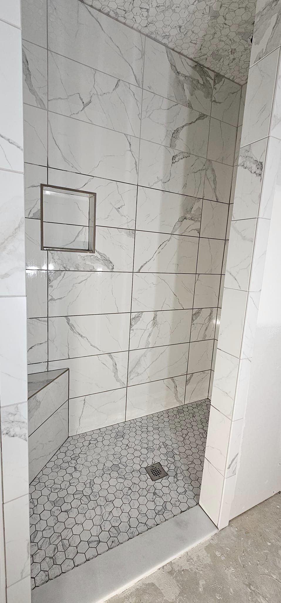 walk in shower with marble tile